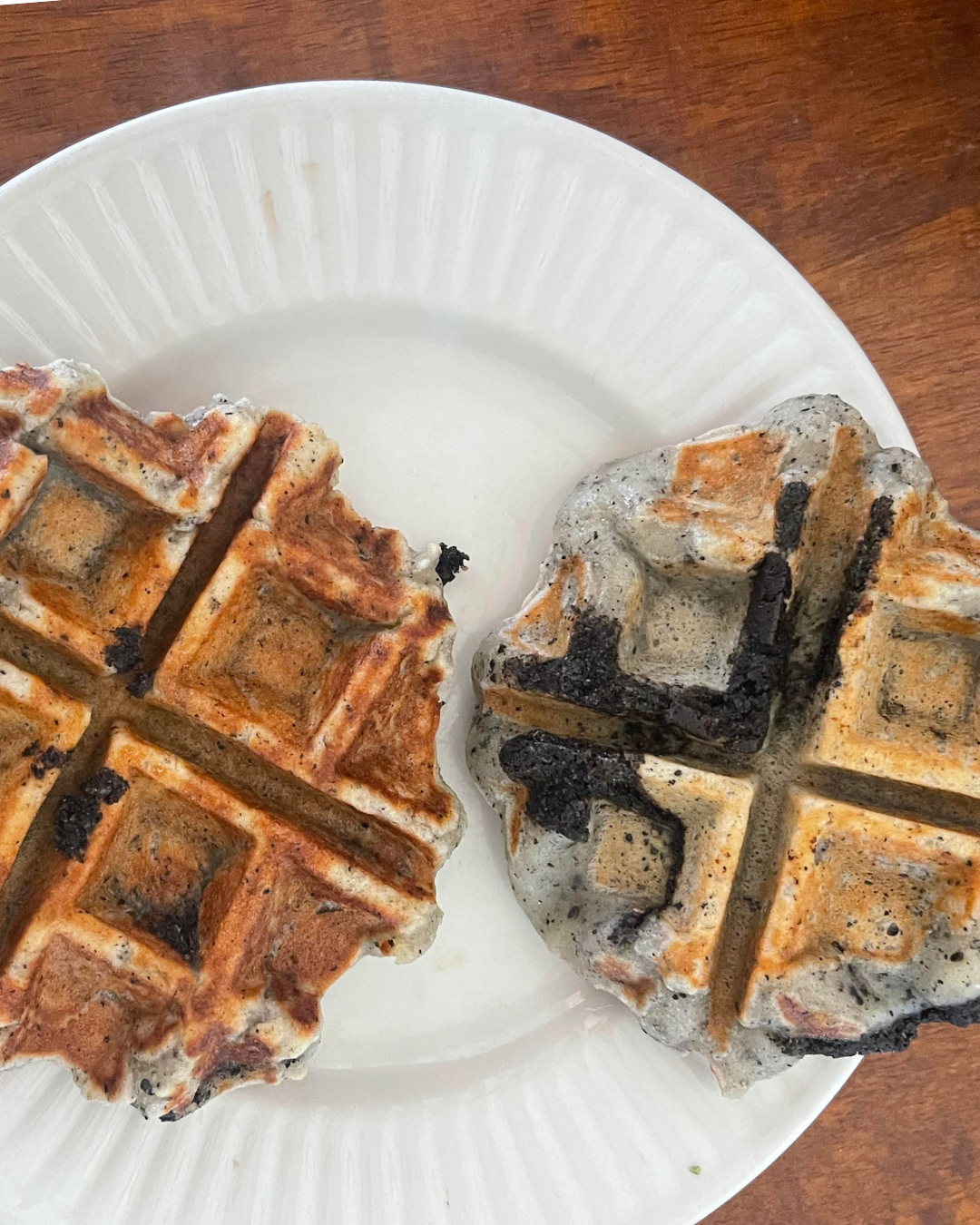 Photo: Two black sesame mochi waffles on a breakfast plate, with black paste accentuating the waffle edges